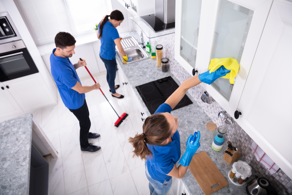 Professional residential cleaning team working in a modern kitchen